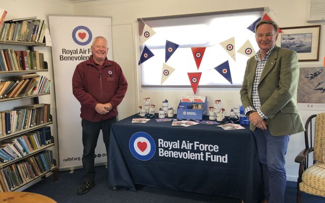 Table of materials and banner with Gavin Davey smiling