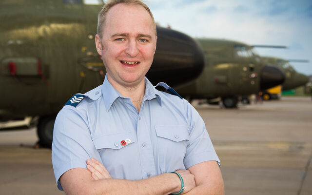 Glen Evans in front of plane in uniform