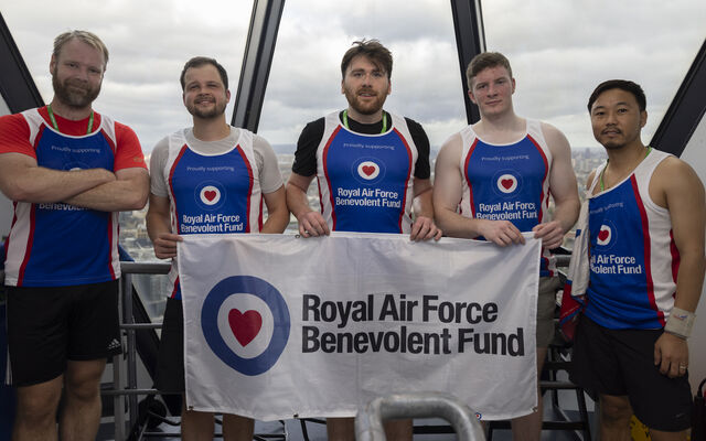 Team in Fund vests holding Fund flag at top of Gherkin tower