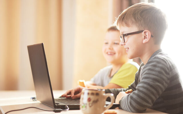 Two young boys looking at laptop