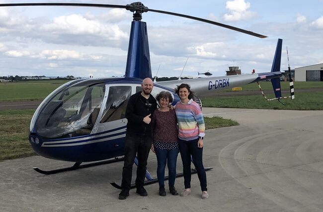 Rosie her mum and brother in front of helicopter