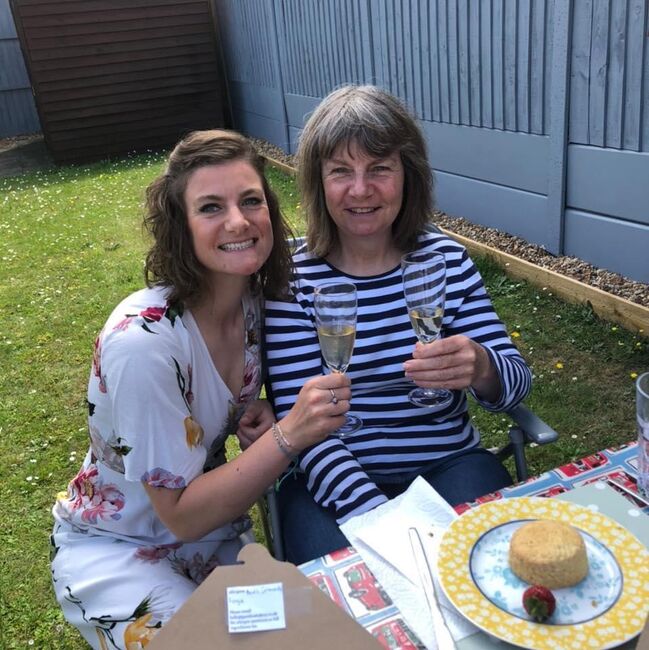 Rosie and Dawn smiling over afternoon tea