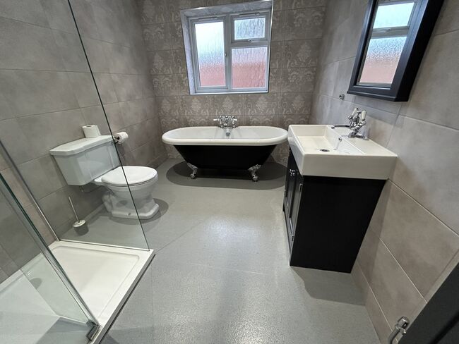 A modern bathroom with toilet and bath tub