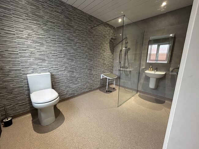 A modern bathroom with toilet and shower