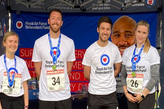 3 runners and Liam standing smiling in Fund tshirts