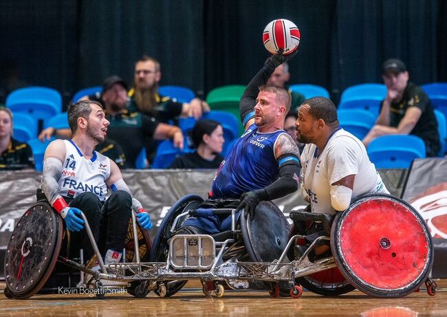 Stu wheelchair rugby action shot with 2 other players