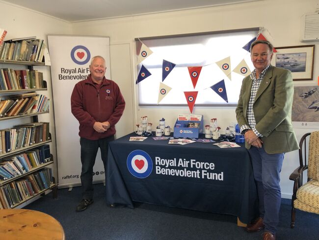 Table of materials and banner with Gavin Davey smiling