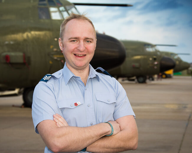 Glen Evans in front of plane in uniform