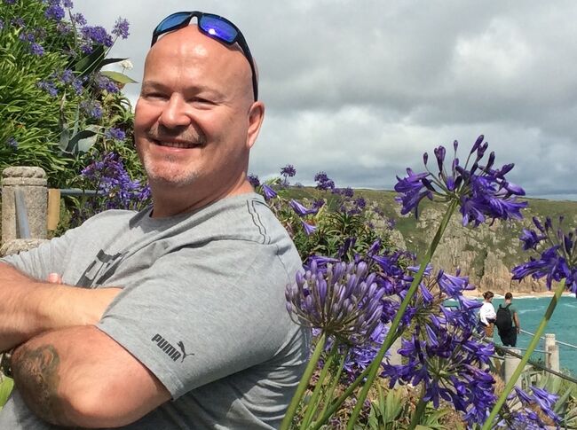 Craig smiling in sunny garden