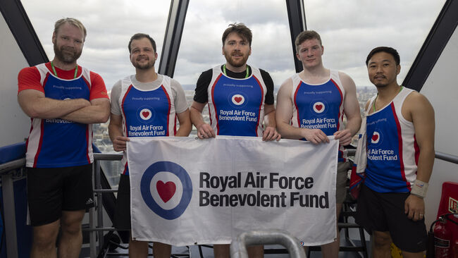 Team in Fund vests holding Fund flag at top of Gherkin tower