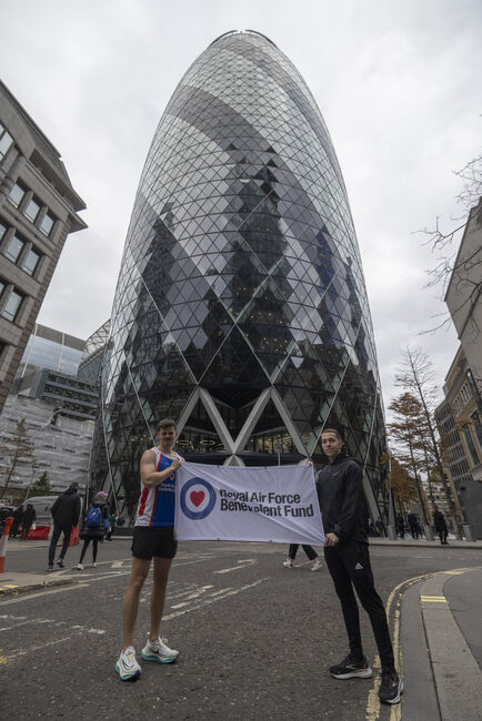 2 personnel holding Fund flag outside Gherkin building