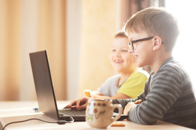 Two young boys looking at laptop