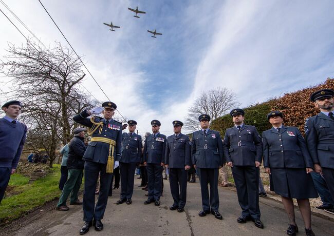 RAF personnel saluting flypast